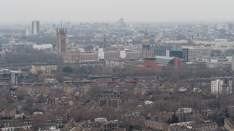 Overcast and Hazy, Westminster Parliament, Big Ben, train passing by, Establishing Aerial View Shot of London UK, United Kingdom