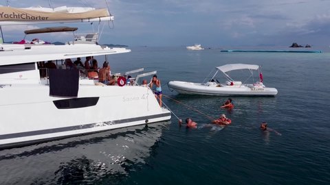 Phuket, Thailand, 20, December, 2019:
A large group of tourists rest on board a sailboat during a sea cruise, many people on a sailing catamaran