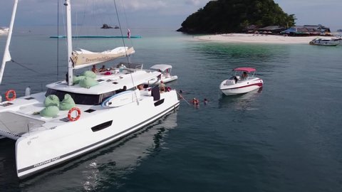 Phuket, Thailand, 11, January, 2022:
A group of tourists resting on board a sailing boat, tourists during a cruise on a sailing catamaran