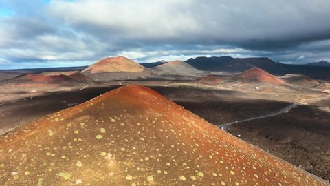 Top view of Lanzarote volcanoes. Drone flight over Lanzarote island in the morning. Aerial view of Canary islands, Spain. landscape with volcanoes in the morning light. Sunrise over the volcanoes.