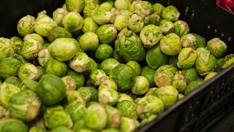 Plastic Crate Box Of Fresh Brussels Sprouts in Grocery Store Vegetables Stand