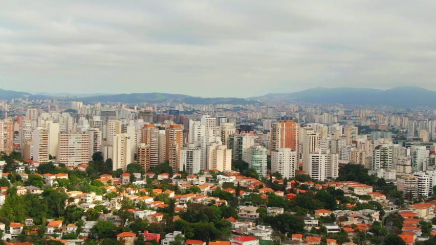 Sao Paulo Skyline during cloudy day with sun between clouds drone footage over Sao Paulo capital