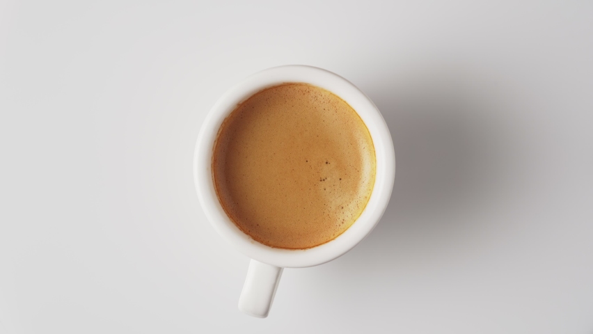 Cup of fresh aromatic coffee with crema, top view, rotate on white background. | Shutterstock HD Video #1086348824