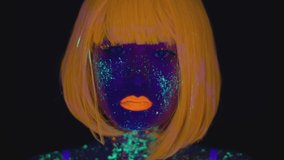 Young asian woman with bright neon body art posing to camera, gesturing with glowing colorful hands in uv light, black studio background, close up portrait - Powered by Shutterstock - Get 15% off with code: PIKWIZARD15