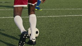 Close up of a soccer dribbling moment on a soccer field. Soccer players are wearing unbranded sports clothes. 4k slow motion video.
