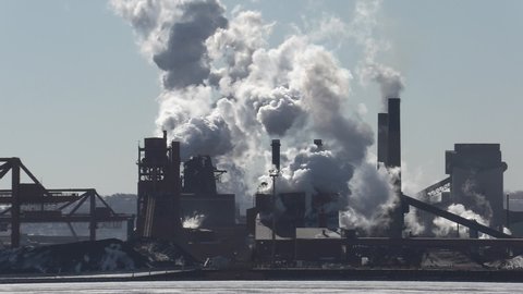 Hamilton, Ontario, Canada January 2022 Massive carbon gas emissions spewing pollution from industrial smokestacks manufacturing steel and coal plants