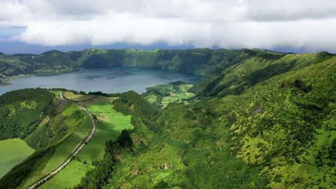 Azores. A lake in the crater of volcano. Sao Miguel island, Portugal. Aerial view of remarkable volcanic landscapes. Lush vegetation on the shores of the crater's lake. High quality 4k footage