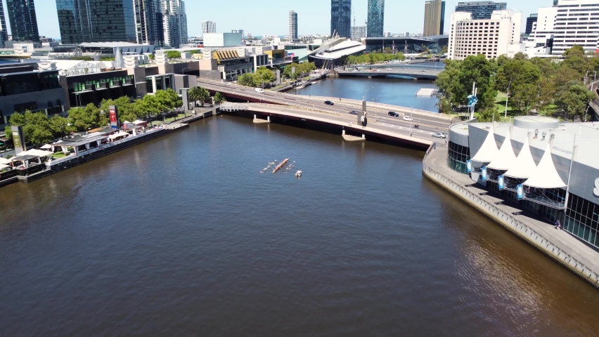Aerial drone shot of Casino Bridge rowers Yarra River Landscape King Street Bridge Melbourne City CBD Victoria Australia 4K