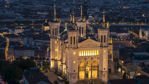 Lyon, France - circa 2021 - Basilica of Notre-Dame de Fourviere, Establishing Aerial View Shot of Lyon Fr, Auvergne-Rhone-Alpes, France at night evening, paralax left