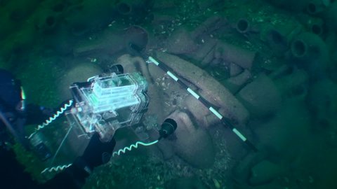 ZMEINIY ISLAND, BLACK SEA, UKRAINE - AUGUST 2013: Underwater archeology: video recording of artifacts on a sunken antique Greek ship.
