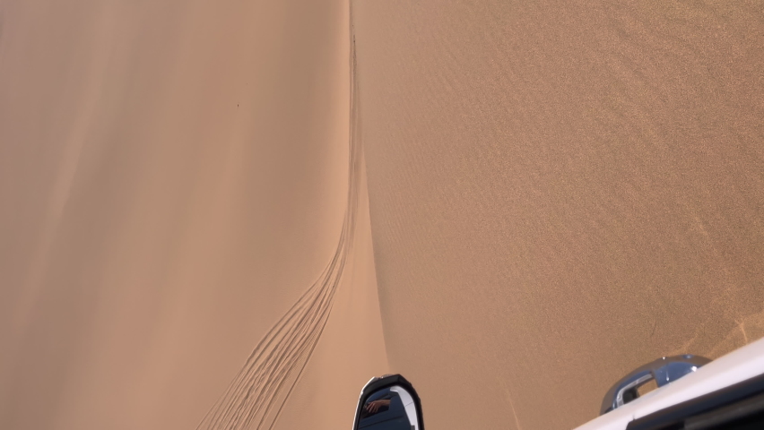 Vertical video. Car driving sand dunes. Dune driving in desert. Indoors white SUV auto off road travel in Africa or UAE. Sunny day. Summer vacation, trip safari. Royalty-Free Stock Footage #1086370310