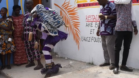 Abidjan,ivory coast- December 12, 2021: A mask dancing in front of a lady showing her her best dance steps..