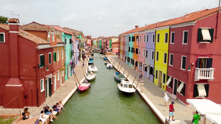 Aerial panoramic view of the painted facades of Burano island a province of Venice in Italy on a sunny day. Royalty-Free Stock Footage #1086376439
