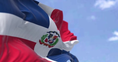 Detail of the national flag of the Dominican Republic waving in the wind on a clear day. Democracy and politics. Patriotism. Selective focus. Caribbean country. Seamless Slow motion