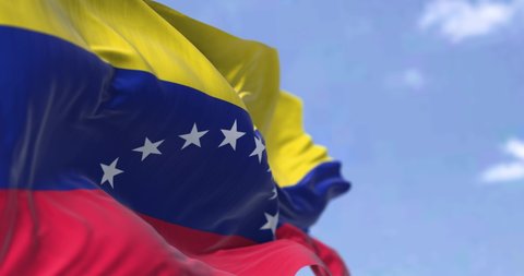 Detail of the national flag of Venezuela waving in the wind on a clear day. Democracy and politics. Patriotism. Selective focus. South american country. Seamless Slow motion