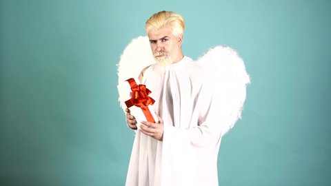 Funny Valentines Day. Crazy bearded angel man with valentine gift. Humor comical concept.