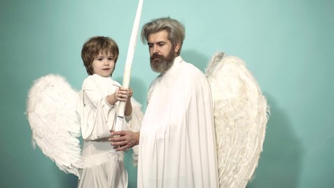 Funny cupid, father and son on valentine day with bow arrow shooting. Love family concept. Fun angels. Valentin man with angel wings. Valentines Day. Parenting, parent with child boy, childhood.