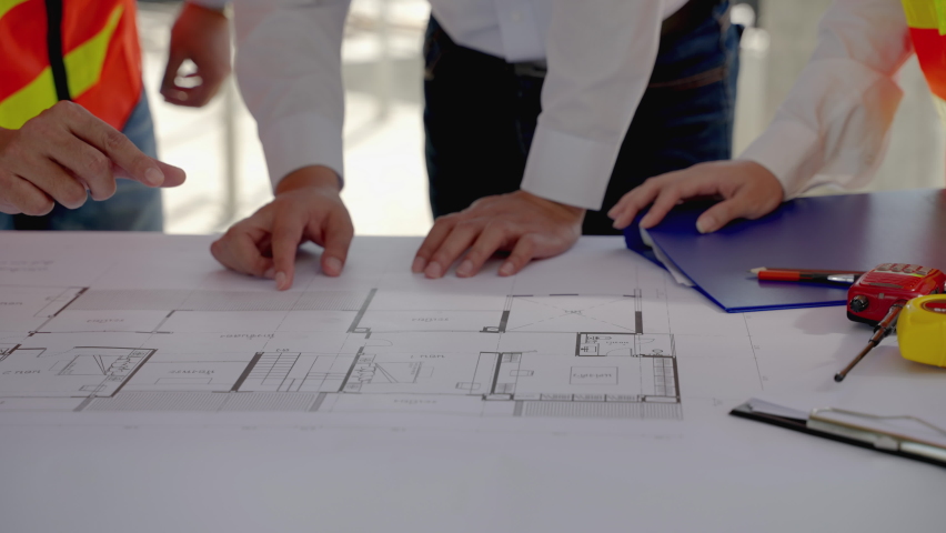 Civil engineering team Along with the architect and foreman watching the Blue Print and planning the construction of the building on the construction site. | Shutterstock HD Video #1086382202