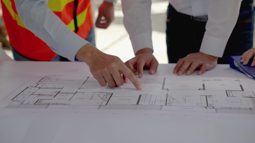 civil engineering team Along with the architect and foreman watching the Blue Print and planning the construction of the building on the construction site. Royalty-Free Stock Footage #1086382202