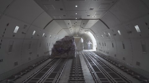 Loading air cargo freighter inside aircraft hold loop.
