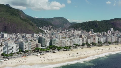 Aerial view Rio de Janeiro Brazil cityscape. Copacabana city area with skyscrapers expensive hotels roads with transport and beautiful mountains in the background.