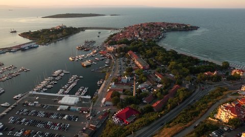 Aerial of seaside town Sozopol, Bulgaria during summer sunset. Huge parking place nearby the port
