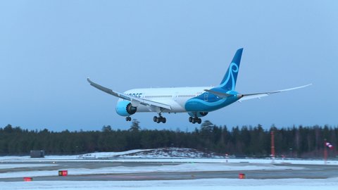 Oslo Airport Norway - January 27 2022: airplane boeing 787 dreamliner norse atlantic airlines arrival landing rear view winter light
