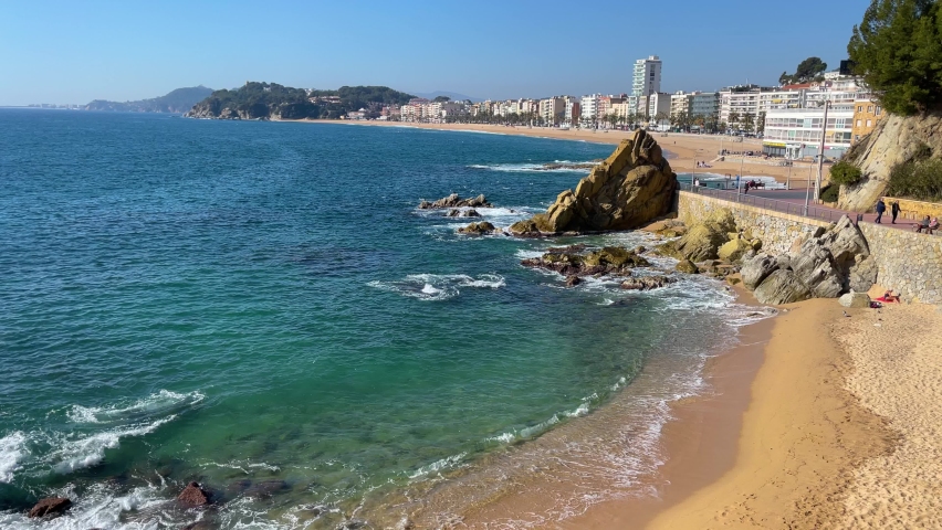Lloret de Mar beach Costa Brava city of Gerona in Spain turquoise blue Mediterranean water background buildings beach without people