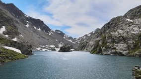 drone video above an alpine glacial lake in summer time