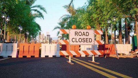 A large road-closed sign in the middle of a road, surrounded by heavy-duty bollards and construction equipment, blocks all traffic from entering the road into the city.