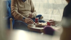 Elderly couple drinking tea at their home. Happy senior couple sitting in lounge and holding cups of tea or coffee. Slow motion and close up.  - Powered by Shutterstock - Get 15% off with code: PIKWIZARD15