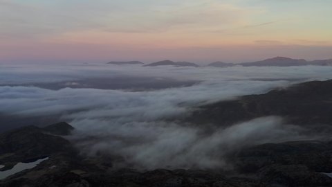Dark aerial view of Snowdonia in Wales UK at sunrise with low cloud
