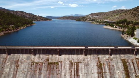 Dam of El Burguillo Reservoir is located along Alberche river in province of Avila, drone point of view during sunny summer day. Spain