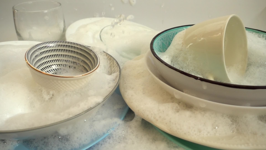 Washing dishes with detergent and water. Slow motion. Royalty-Free Stock Footage #1086406988
