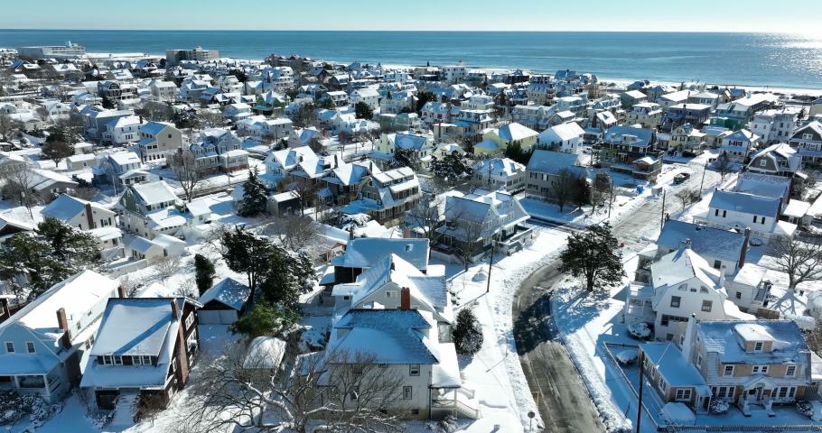 Cape May, New Jersey, USA. Victorian homes covered in winter snow by Atlantic Ocean.