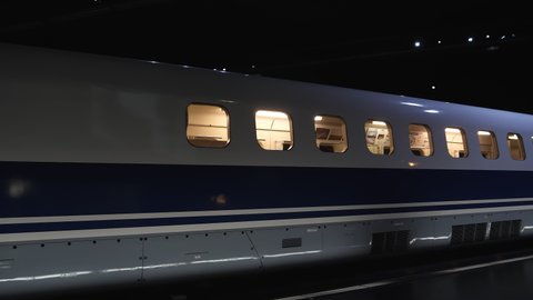 Nagoya.Japan-October 31.2019: Bullet train in Nagoya Japan being displayed inside a train museum. Fast transportation. Modern design. White blue and grey. Camera slowly turning right.