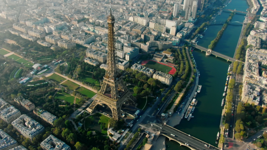 Aerial Panorama of Paris Cityscape with Eiffel Tower on Champ de Mars and Seine River. Landmark French Monument in Historic City Center. Most Visited Travel European City. 4K drone top down orbit shot