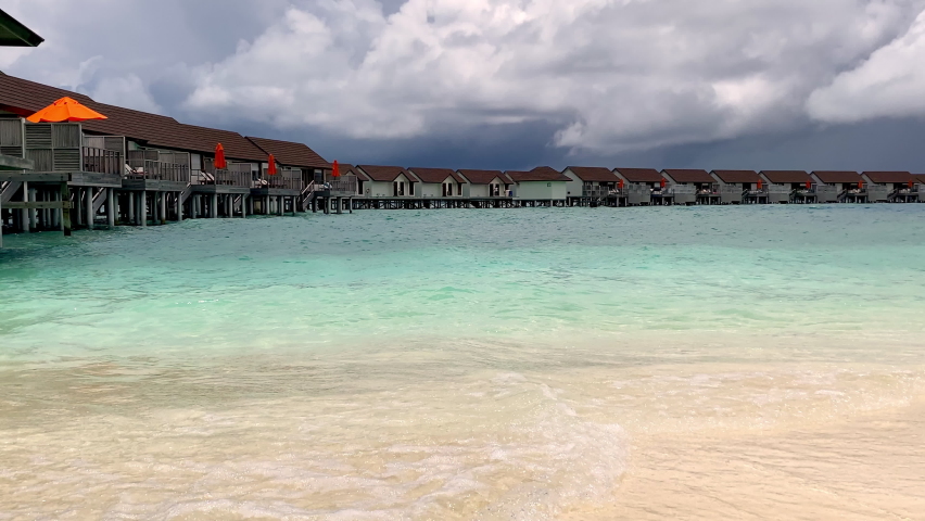 Man walks along the seashore go swimming on the Maldives island. Travel time. Romantic honeymoon. Enjoys the rest and his beloved