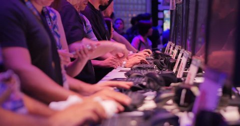 LOS ANGELES - June 17: Gamers testing demo video games at E3 2015 expo. Electronic Entertainment Expo, commonly known as E3, is an annual trade fair for the video game industry. 4K UHD