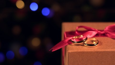 Gift Box Colorful Bokeh and Shiny Wedding Rings