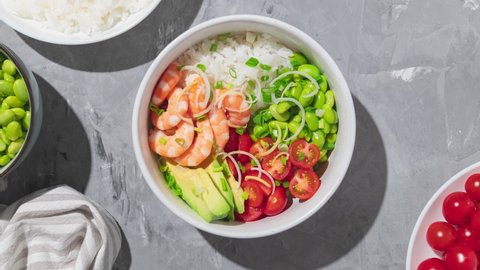 Hawaiian poke bowl with shrimps, rice and vegetables. Healthy bowl with prawns, rice, edamame beans, tomato and avocado. Stop motion animation. Vídeo Stock