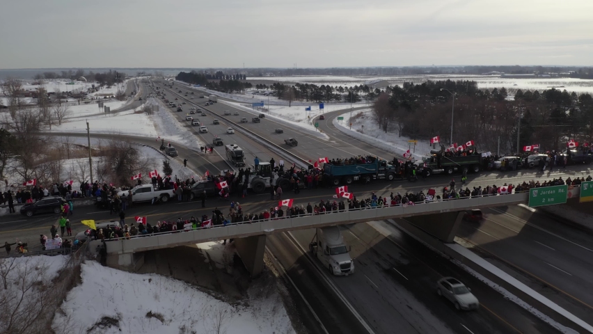 Aerial shot from the other side of the Victoria Bridge located in Vineland, Ontario. People gather supporting the Freedom Convoy 2022. 4K, 29.97