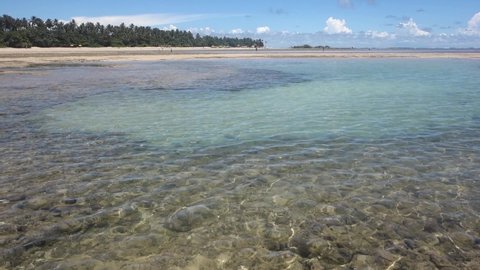 Static view of shallow clean sea water during low tide with the view of sea bed in Morro de Sao Paulo, village in Tinhare island in Bahia, Brazil