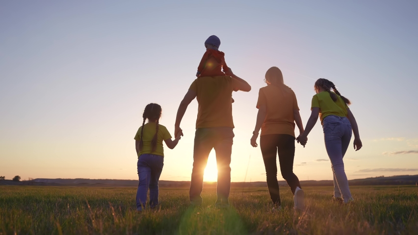 people in the park. happy family walking together in the park silhouette. friendly family kid freedom concept. happy family walking holding hands in the park on the grass. friendly family sunset Royalty-Free Stock Footage #1086440225