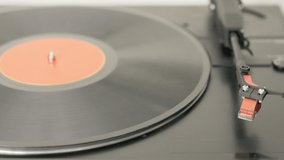 Record player starting to play a 12 inch vinyl record. Realtime video