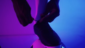 Close up of black african male soccer player tying shoelace on studio, slow motion. Footballer tying his shoe. Low section. tying football boots preparing for a football soccer match - Powered by Shutterstock - Get 15% off with code: PIKWIZARD15