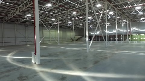 Aerial drone view of the empty industrial  warehouse interior.