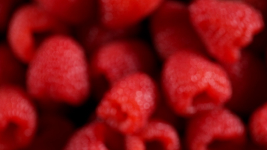 Super Slow Motion Detail Shot of Flying and Rotating Fresh Raspberries at 1000fps. Royalty-Free Stock Footage #1086443201