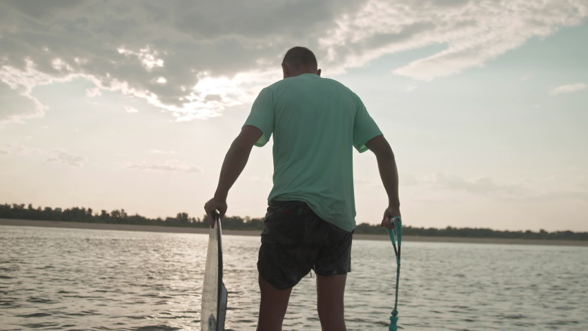 A man on a motor boat with a wakeboard