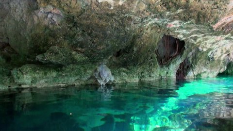 Scuba diving underwater in Yucatan Mexico cenotes. Diver in clean and clear underground water.